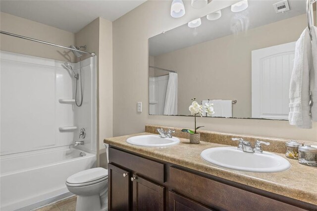 8553 Braylen Manor Dr, Douglasville, GA 30134 - bathroom featuring double vanity, shower / bath combo with shower curtain, and tile patterned floors