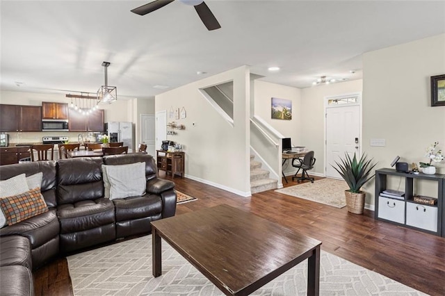 8553 Braylen Manor Dr, Douglasville, GA 30134 - living room with stairs, light wood finished floors, and a ceiling fan
