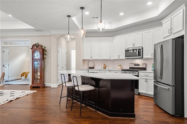 kitchen featuring dark hardwood / wood-style flooring, sink, pendant lighting, and appliances with stainless steel finishes