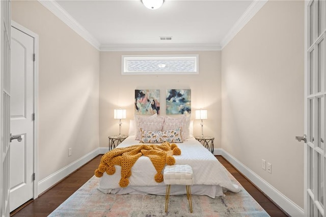 bedroom with dark hardwood / wood-style floors and ornamental molding