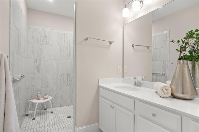 bathroom with vanity and tiled shower