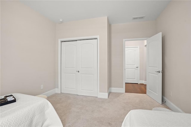 carpeted bedroom with a closet