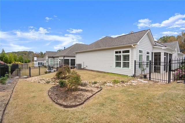 back of house featuring a yard, central AC, and a sunroom