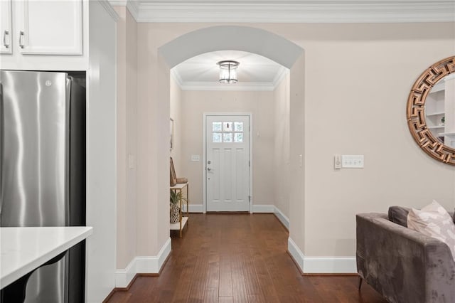 foyer entrance with dark wood-type flooring and ornamental molding