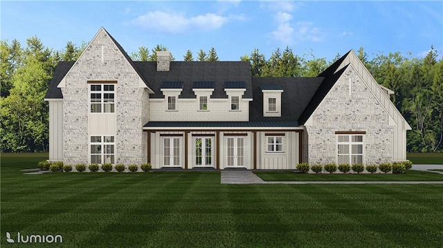 view of front of house with metal roof, stone siding, french doors, a standing seam roof, and a front yard