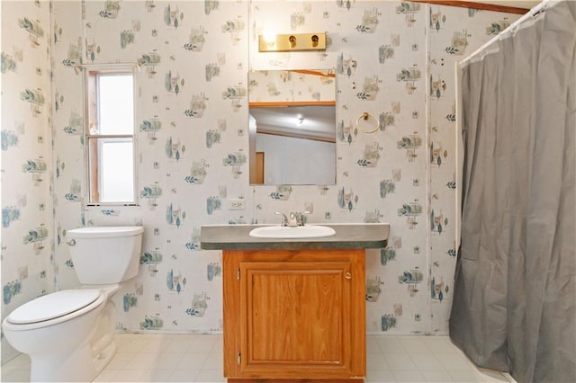 bathroom featuring vanity, toilet, and wallpapered walls