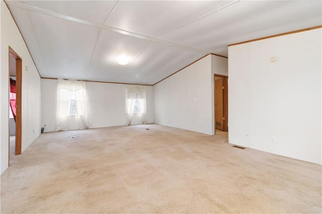 spare room featuring lofted ceiling and carpet floors