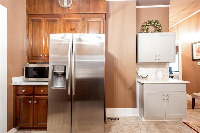 791 E Main St, Canton, GA 30114 - kitchen with stainless steel appliances, light countertops, baseboards, and backsplash