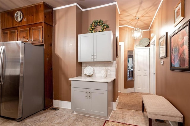 791 E Main St, Canton, GA 30114 - kitchen with freestanding refrigerator, light countertops, crown molding, tasteful backsplash, and baseboards
