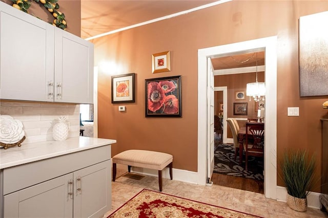 791 E Main St, Canton, GA 30114 - laundry area featuring a chandelier, ornamental molding, and baseboards
