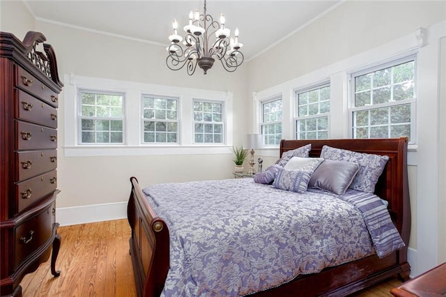 791 E Main St, Canton, GA 30114 - bedroom with a chandelier, light wood-style floors, baseboards, and crown molding