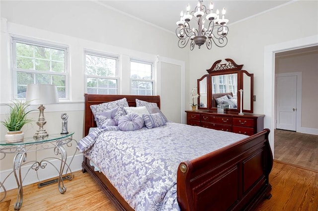 791 E Main St, Canton, GA 30114 - bedroom featuring light wood finished floors, a chandelier, ornamental molding, and baseboards