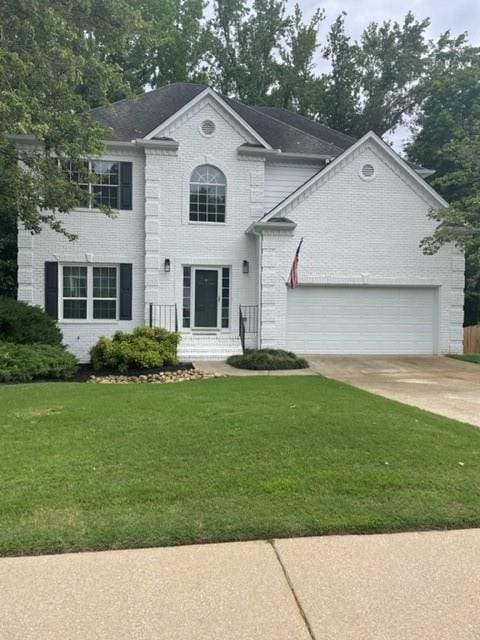 5920 Findley Chase Dr, Johns Creek, GA 30097 - view of front of house featuring brick siding, driveway, an attached garage, and a front lawn