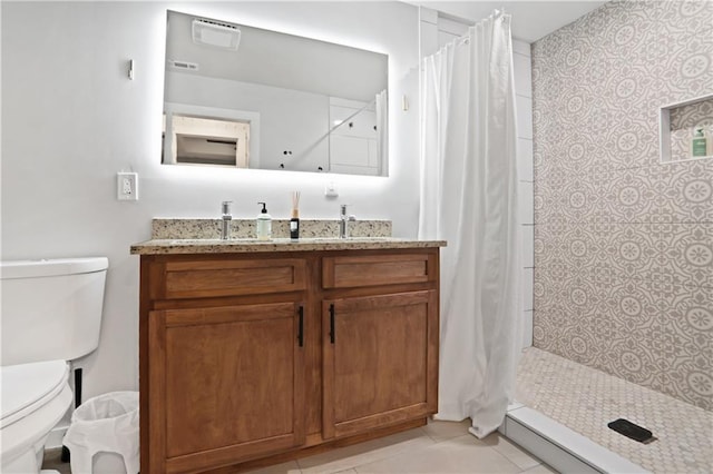 1202 Key Rd SE, Atlanta, GA 30316 - bathroom featuring toilet, vanity, a tile shower, and tile patterned floors