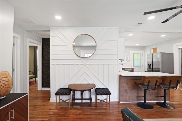1202 Key Rd SE, Atlanta, GA 30316 - interior space with stainless steel refrigerator with ice dispenser, dark wood-type flooring, a breakfast bar area, a peninsula, and recessed lighting