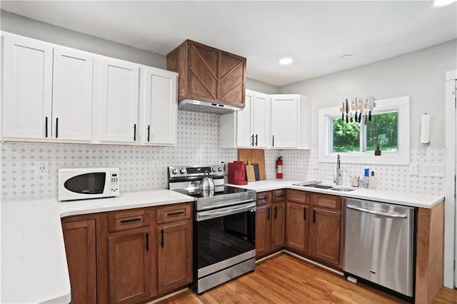 1202 Key Rd SE, Atlanta, GA 30316 - kitchen with stainless steel appliances, a sink, under cabinet range hood, light countertops, and recessed lighting