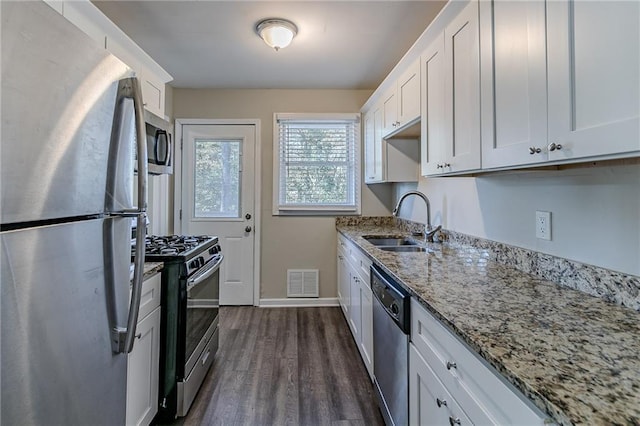 2329 Meadowlane Dr SW, Atlanta, GA 30311 - kitchen with white cabinets, dark hardwood / wood-style flooring, stainless steel appliances, and light stone counters