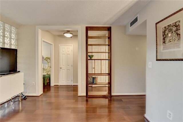 interior space featuring dark hardwood / wood-style flooring and a textured ceiling