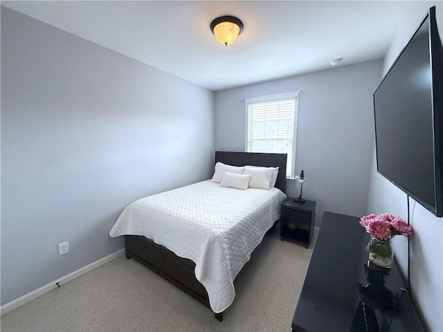 bedroom with carpet and baseboards