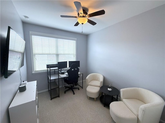 office area featuring light colored carpet, baseboards, and ceiling fan