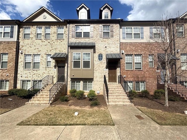 townhome / multi-family property with brick siding