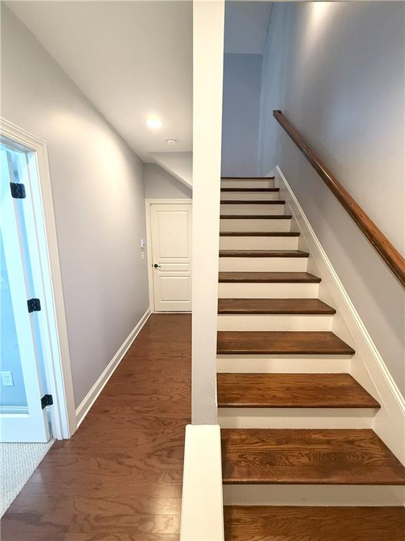 stairs with recessed lighting, baseboards, and wood finished floors
