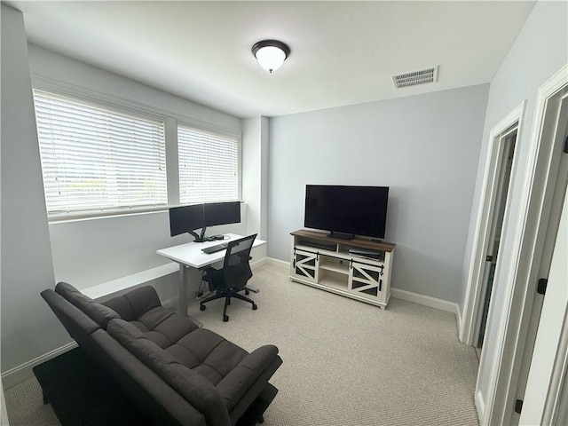 home office with baseboards, visible vents, and carpet floors