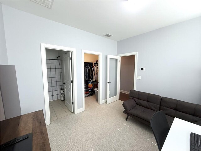 living area featuring baseboards, light carpet, french doors, and visible vents
