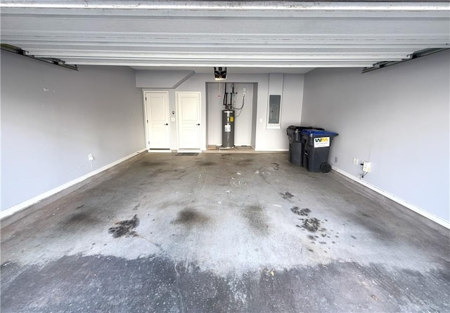 garage with baseboards, electric water heater, and electric panel