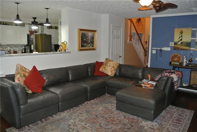 living room featuring a textured ceiling, dark hardwood / wood-style flooring, and ceiling fan