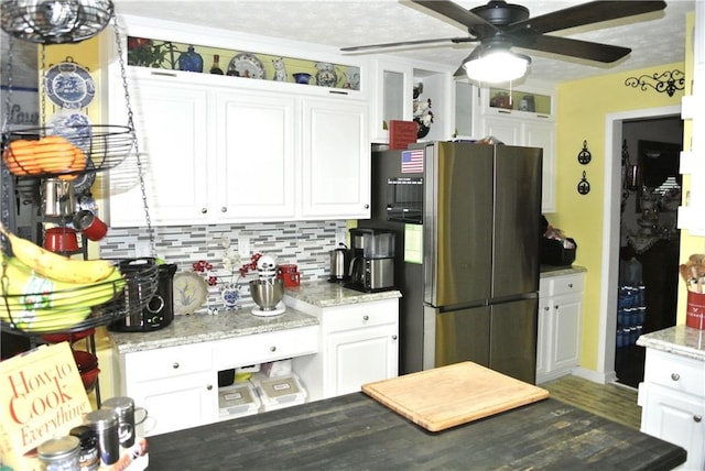 kitchen featuring white cabinets, ceiling fan, stainless steel fridge with ice dispenser, and a textured ceiling