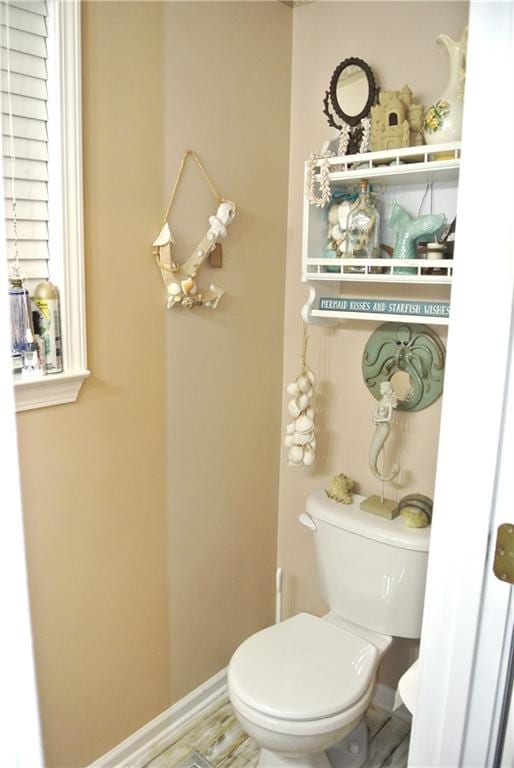 bathroom with hardwood / wood-style floors and toilet