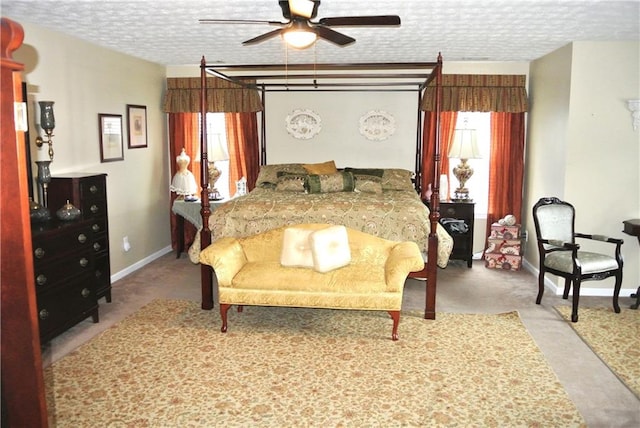 carpeted bedroom with ceiling fan and a textured ceiling