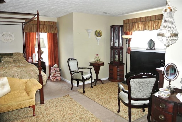 bedroom with a textured ceiling and light colored carpet