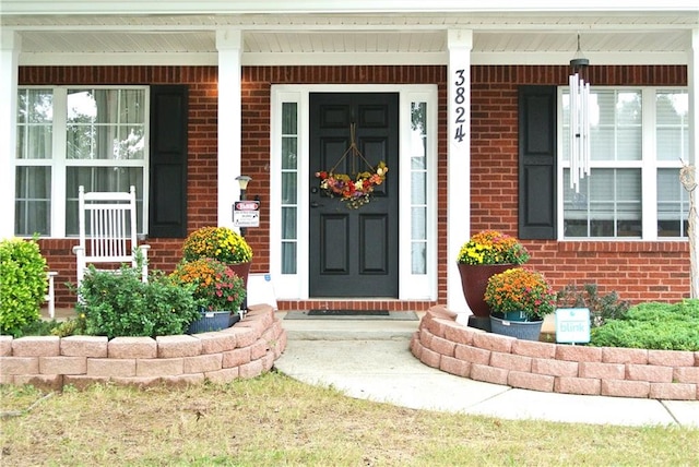 entrance to property featuring a porch