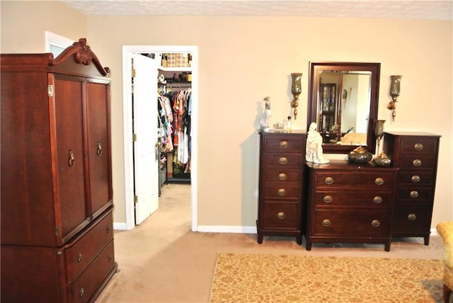 carpeted bedroom with a textured ceiling and a closet