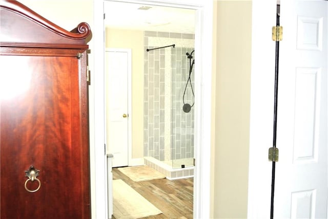 bathroom with walk in shower and hardwood / wood-style flooring