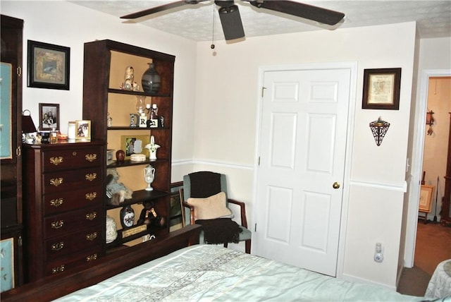 bedroom with a textured ceiling and ceiling fan