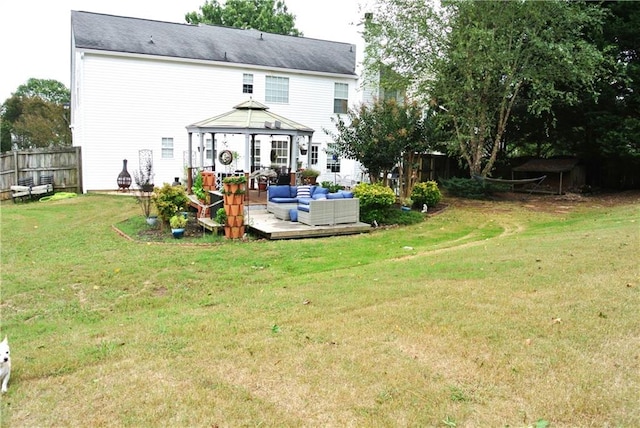 back of property with an outdoor hangout area, a gazebo, and a yard