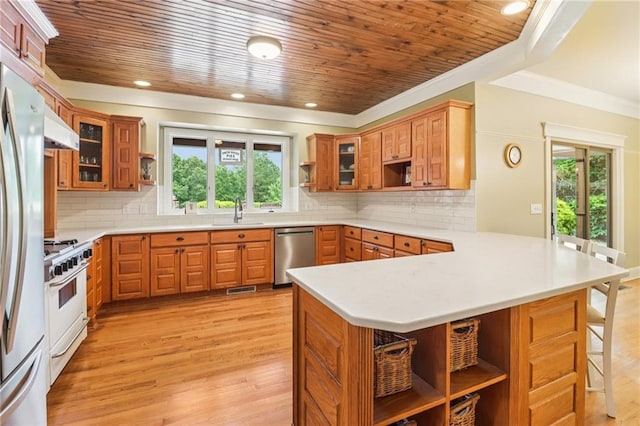 150 Henderson Farm Dr, Woodstock, GA 30188 - kitchen featuring open shelves, stainless steel appliances, a peninsula, a kitchen breakfast bar, and under cabinet range hood
