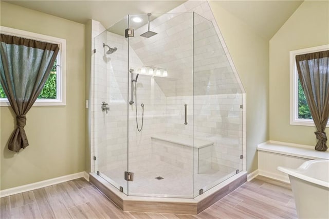 150 Henderson Farm Dr, Woodstock, GA 30188 - full bathroom with a stall shower, a freestanding bath, wood finished floors, vaulted ceiling, and recessed lighting