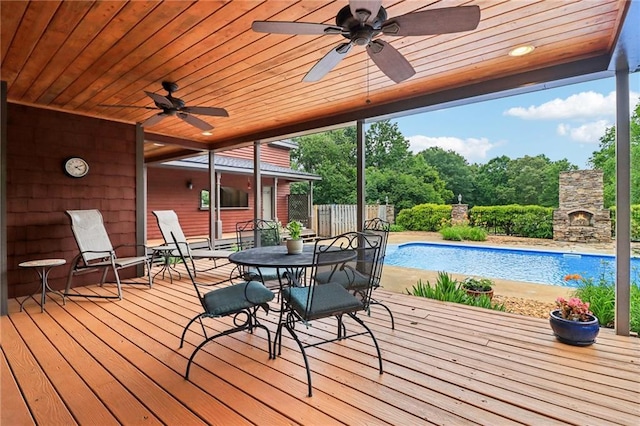 150 Henderson Farm Dr, Woodstock, GA 30188 - wooden terrace featuring ceiling fan, outdoor dining space, an outdoor pool, and a stone fireplace