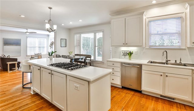 389 Mill Creek Bnd NE, Atlanta, GA 30307 - kitchen with crown molding, visible vents, plenty of natural light, a sink, and stainless steel appliances