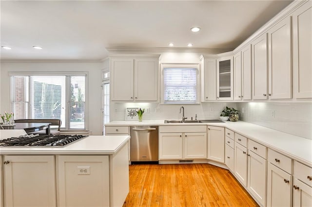 389 Mill Creek Bnd NE, Atlanta, GA 30307 - kitchen with a sink, stainless steel appliances, decorative backsplash, light wood-type flooring, and ornamental molding