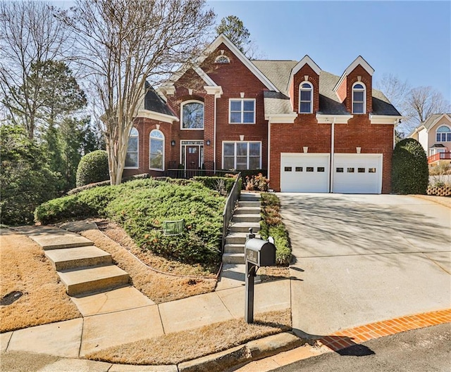 389 Mill Creek Bnd NE, Atlanta, GA 30307 - traditional-style house featuring brick siding, an attached garage, driveway, and stairway