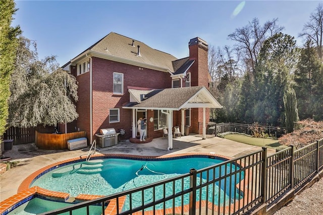 389 Mill Creek Bnd NE, Atlanta, GA 30307 - back of property with brick siding, fence, a chimney, and a patio area