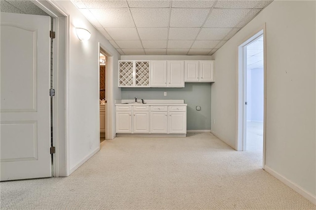 389 Mill Creek Bnd NE, Atlanta, GA 30307 - interior space with a paneled ceiling, a sink, baseboards, light carpet, and white cabinetry