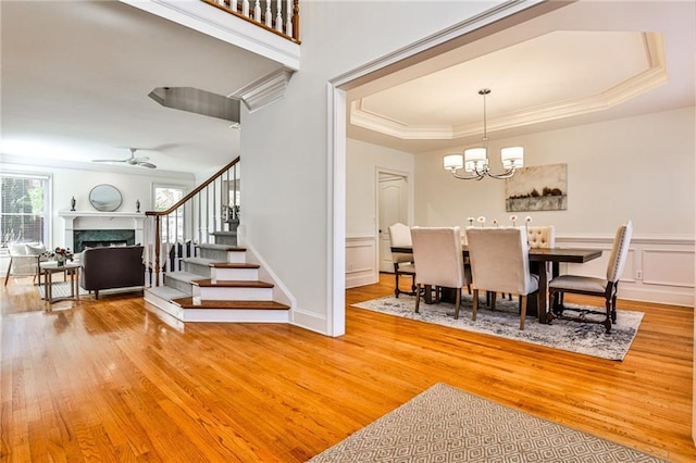 389 Mill Creek Bnd NE, Atlanta, GA 30307 - dining room with light wood-style flooring, a tray ceiling, a premium fireplace, and stairway