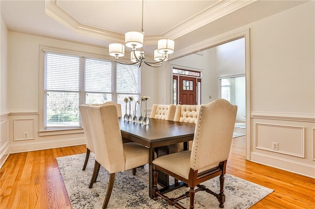 389 Mill Creek Bnd NE, Atlanta, GA 30307 - dining area with crown molding, an inviting chandelier, wainscoting, light wood finished floors, and a decorative wall