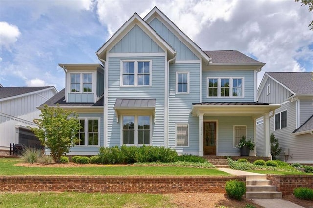 2010 Georgia Club Dr, Statham, GA 30666 - view of front of house featuring board and batten siding, a standing seam roof, and a metal roof